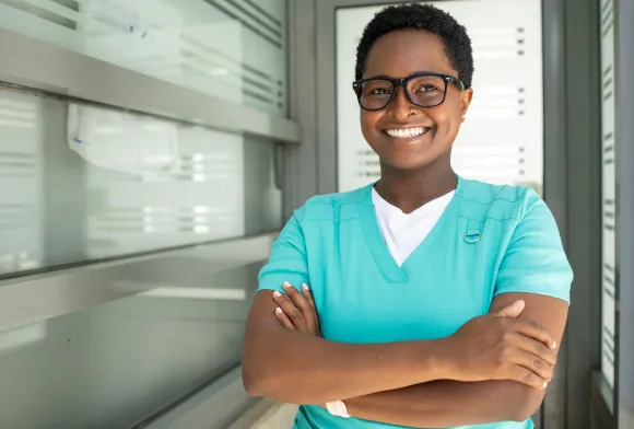 Smiling wound care nurse with blue scrubs