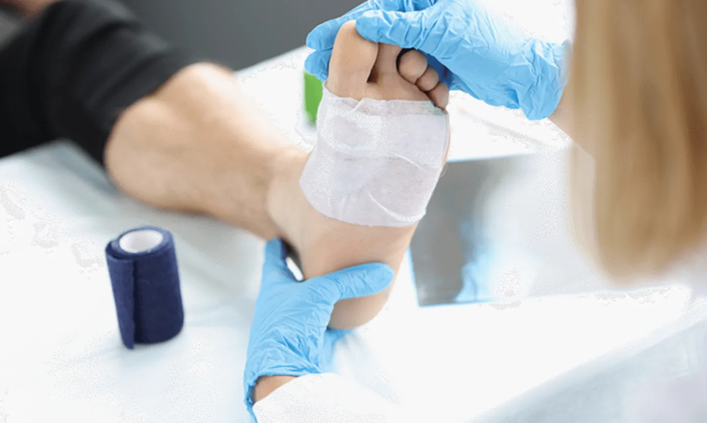 Nurse conducting diabetic wound care on a patient's foot