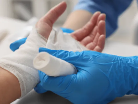 Hand being wrapped in bandage