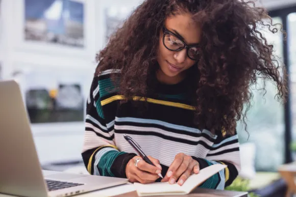 Student taking notes in notebook